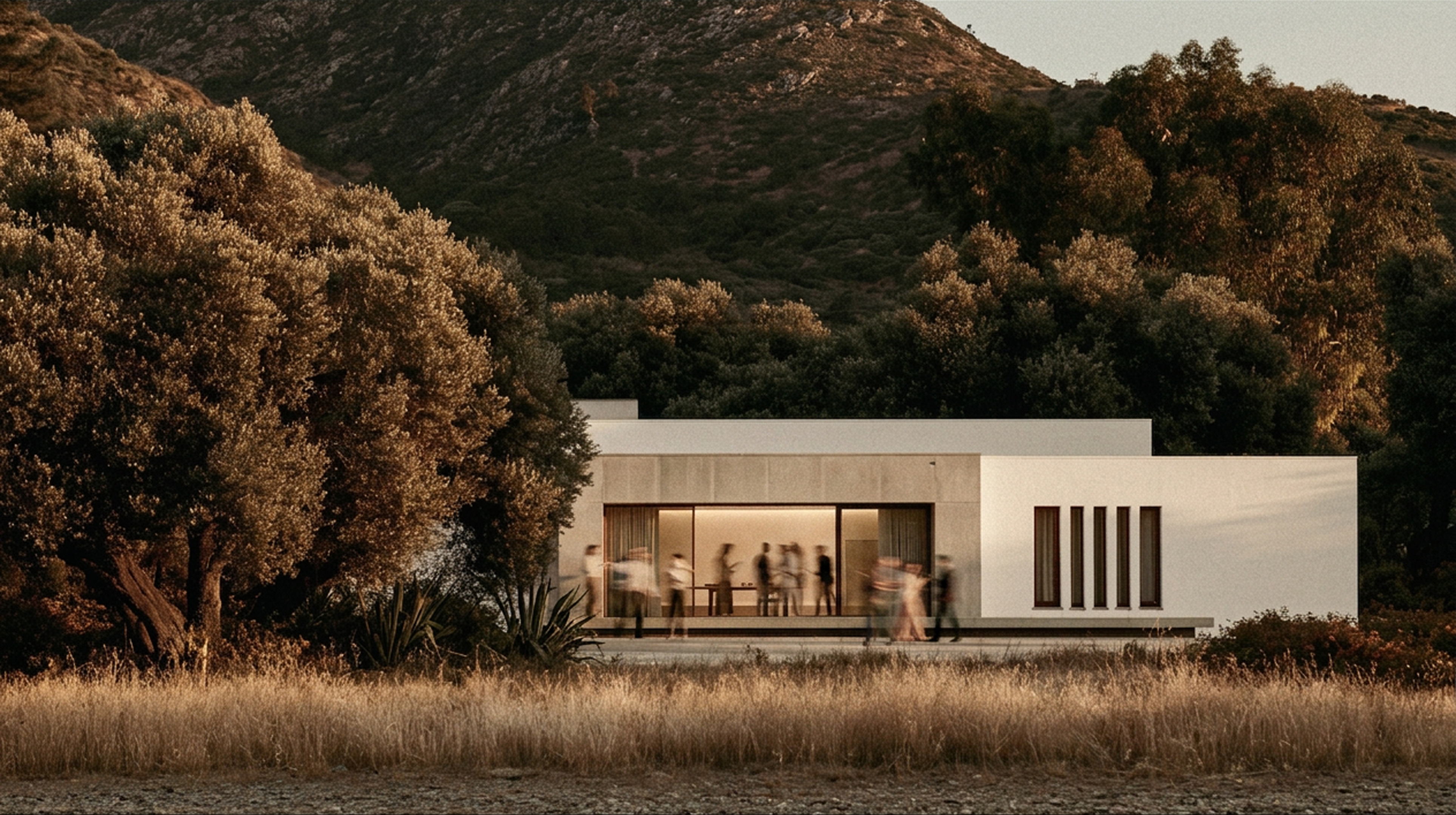 Guests gathering at dusk in a kept estate beneath the cork-oak hills of Arrábida